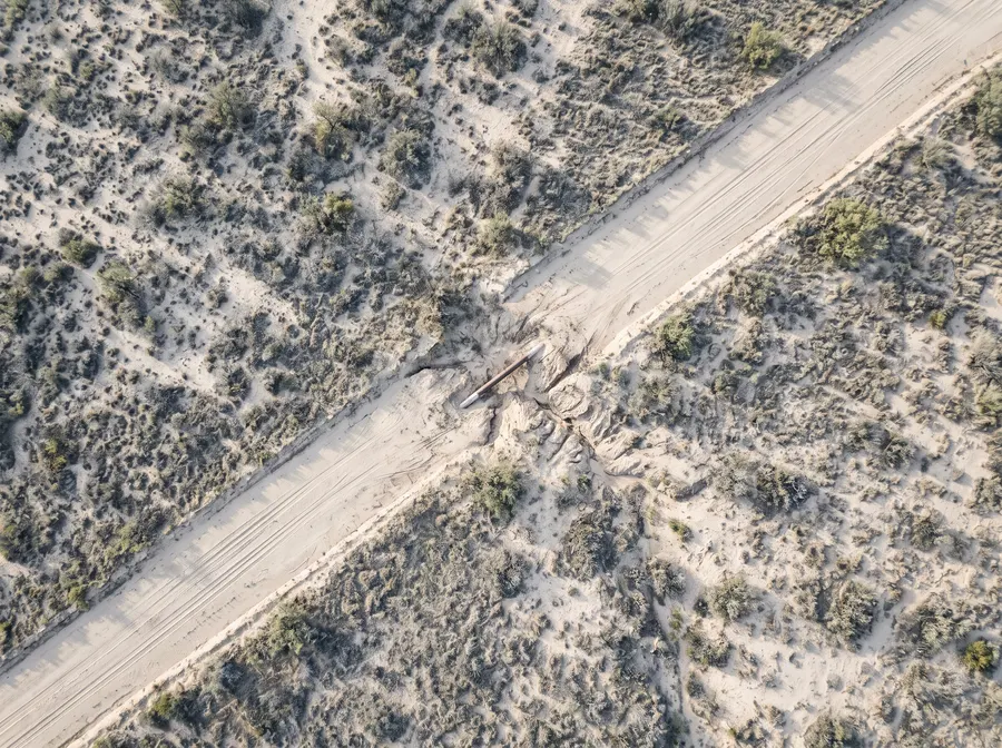 Overhead survey photograph of the right-of-way showing ground disturbance across the corridor
